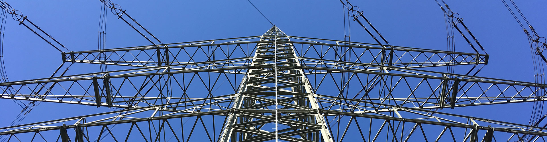 A power pylon on a major overhead power line, photographed from the bottom upwards.